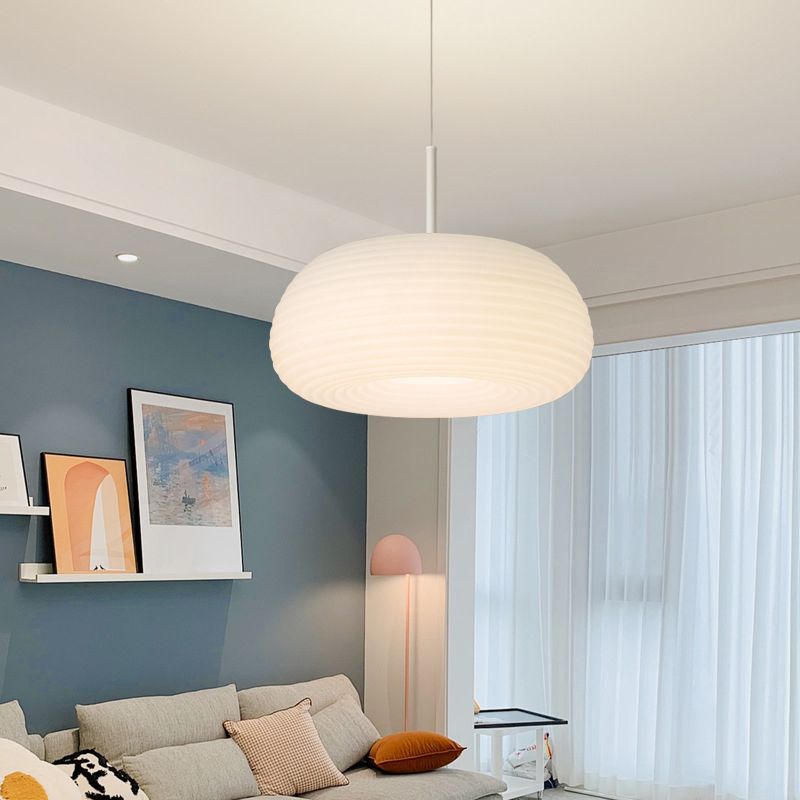 White drum pendant light in a living room
