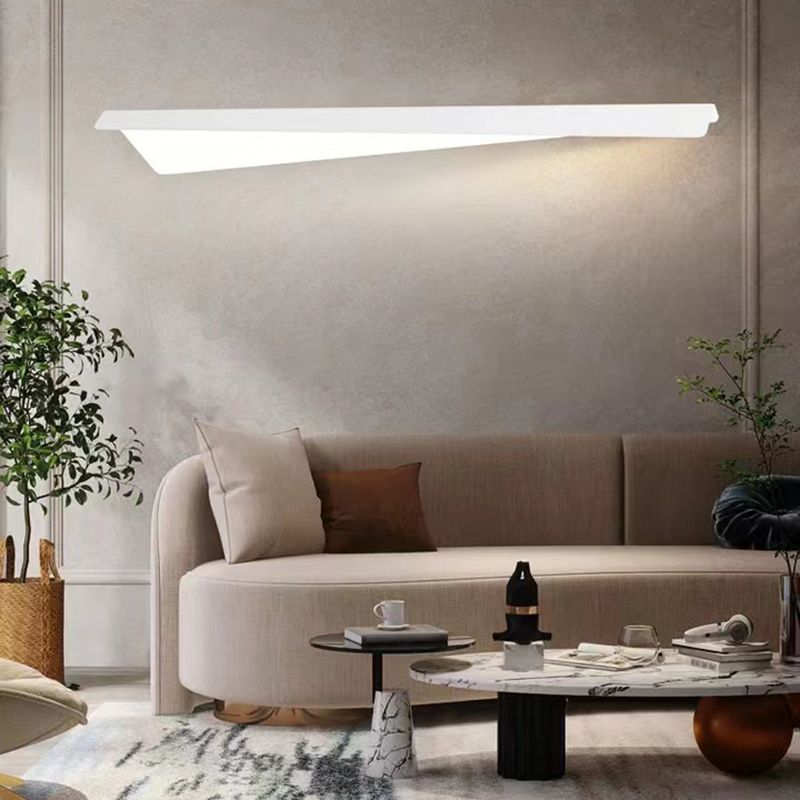 Leigh Fold Wall Lamp illuminating a modern living room setting