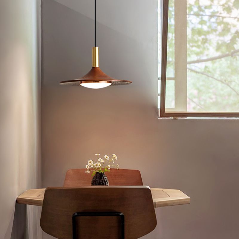 Cap-shaped wooden pendant light over dining table