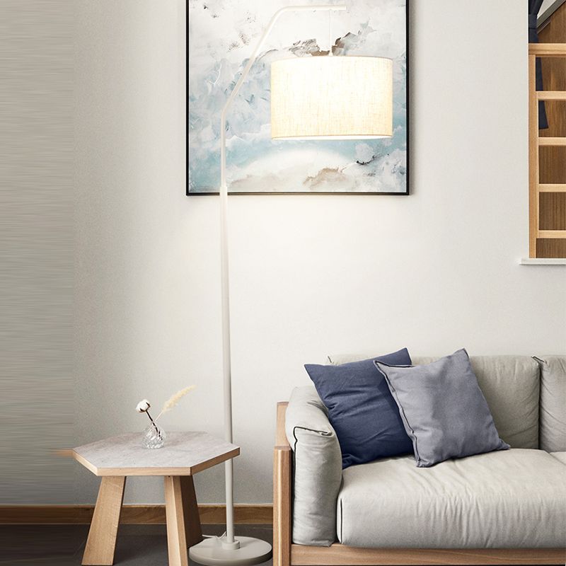 Eryn over-arching floor lamp with fabric shade in living room.