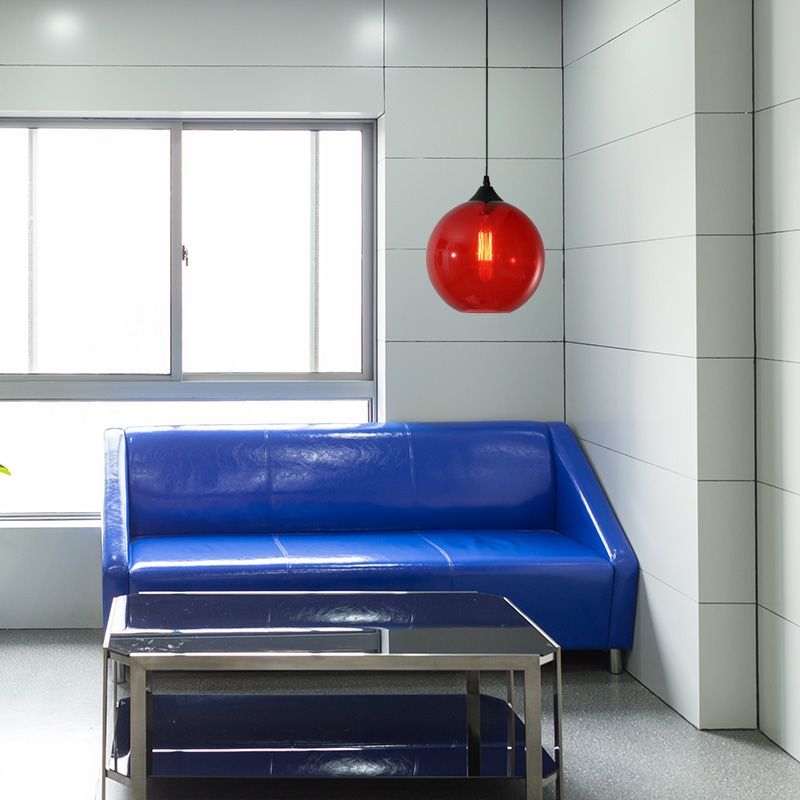 Red Hailie pendant light above blue sofa