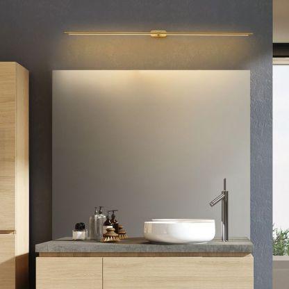 Gold Leigh wall lamp above bathroom mirror. Modern lighting.