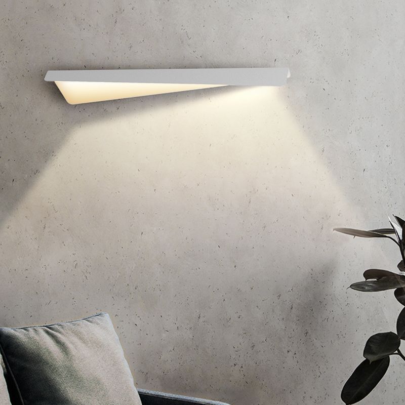 Modern white Leigh Fold wall lamp illuminating a living space
