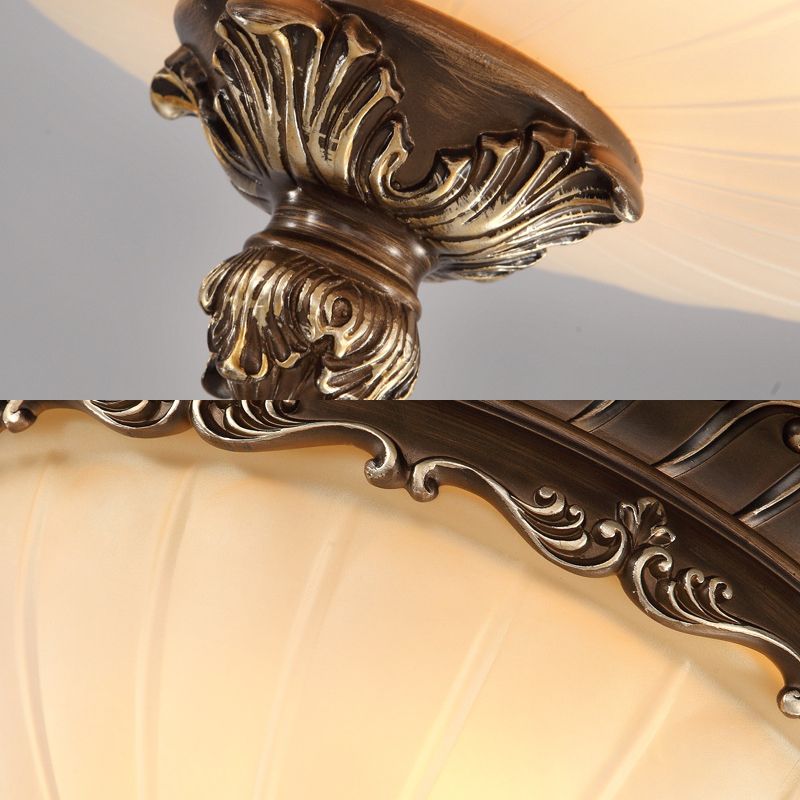 Retro bronze ceiling light with beige glass shade
