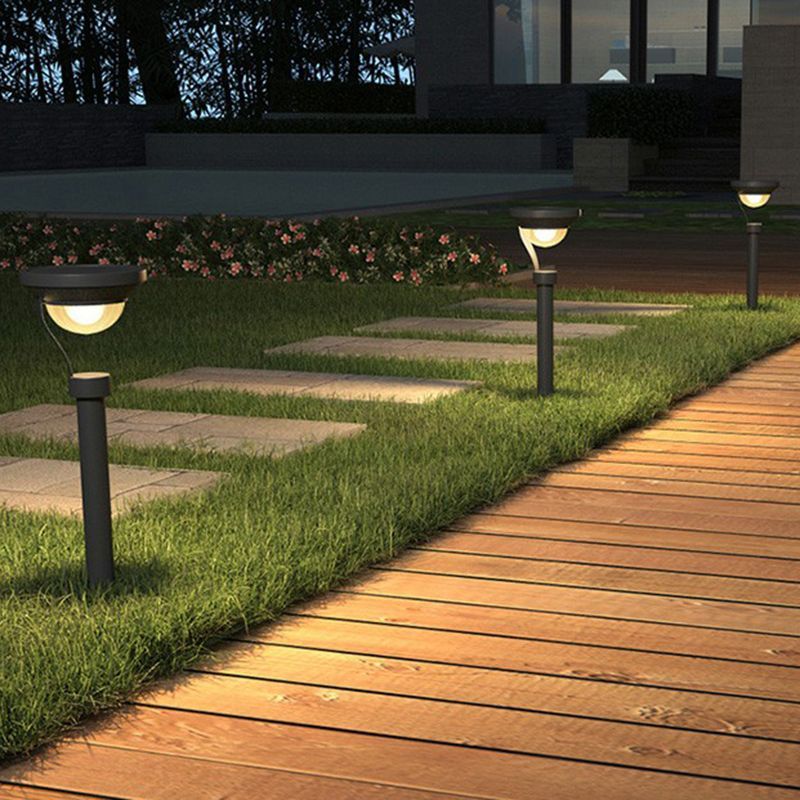 Outdoor bollard lights illuminate wooden pathway