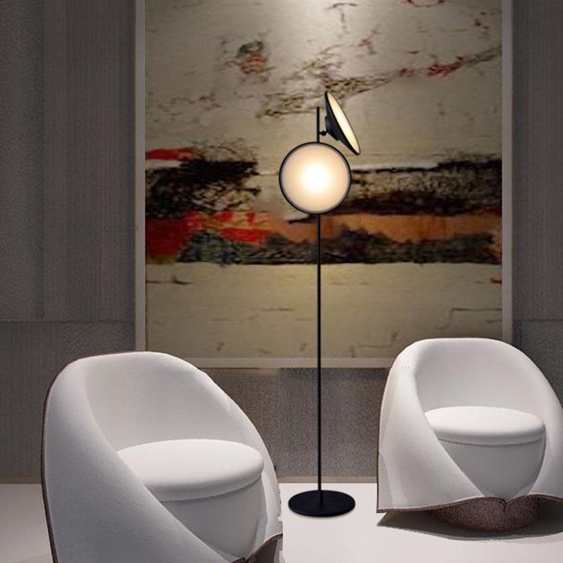 Modern floor lamp beside white chairs