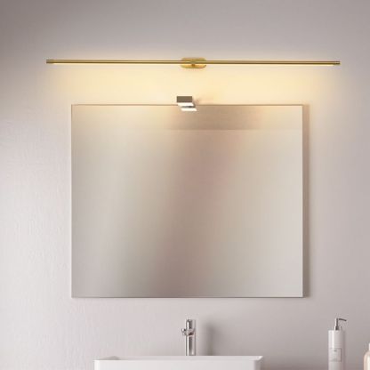 Gold Leigh minimalist wall lamp above mirror. Modern lighting.