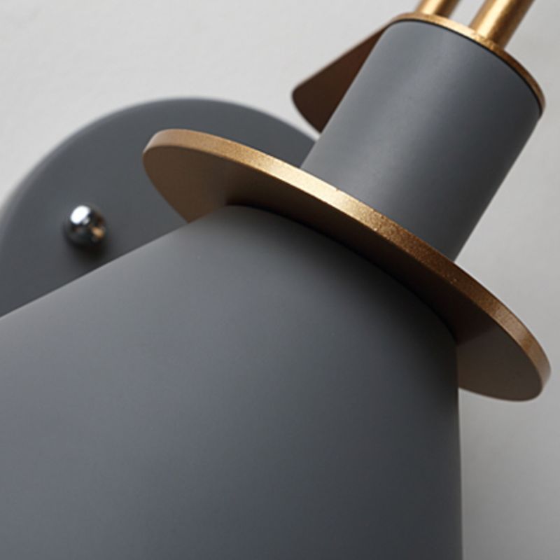 Close-up: gray metal Morandi wall lamp with gold accents