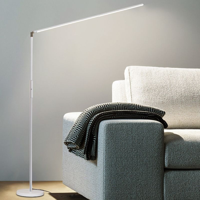 Modern LED floor lamp next to gray sofa