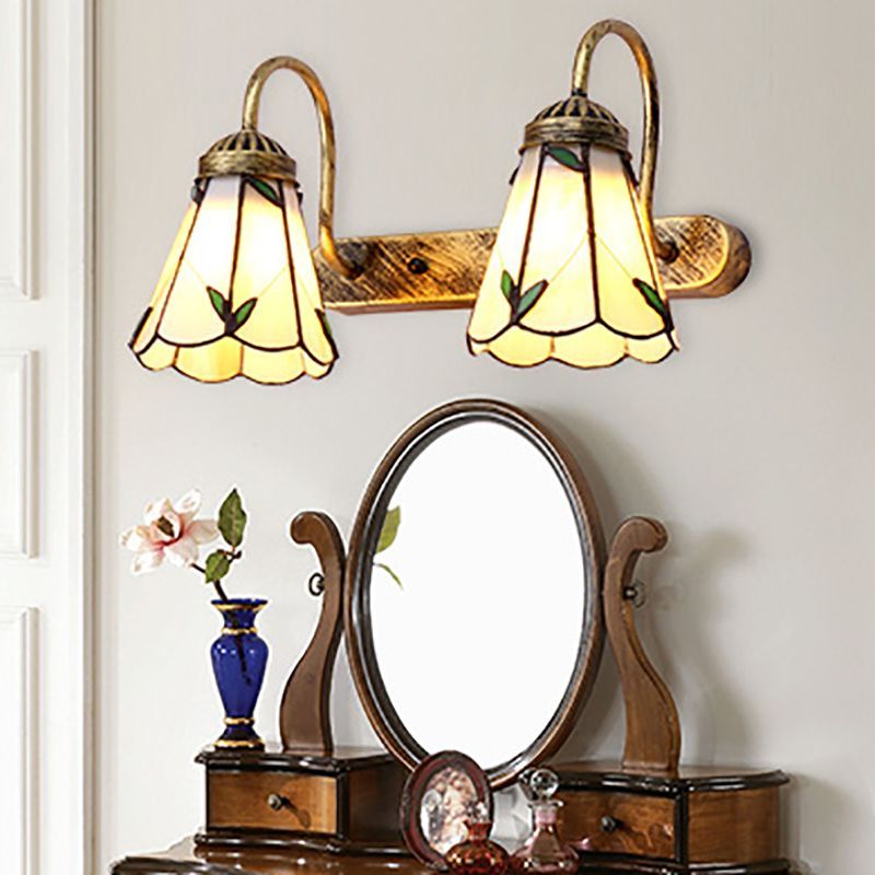 Vintage flower wall lamps over vanity mirror, Las Sola lighting
