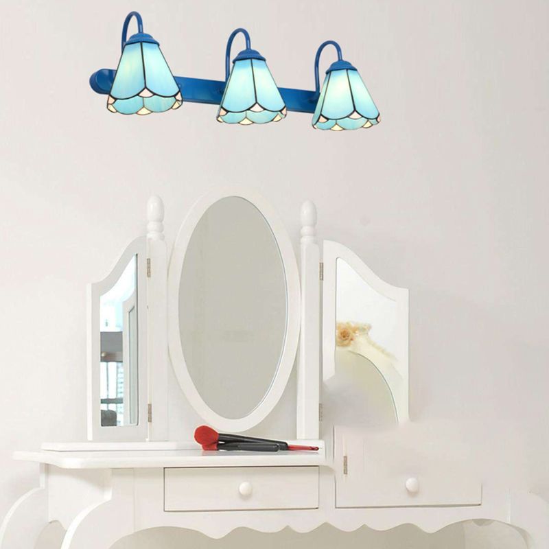Blue flower metal wall lamp over vanity mirror. Las Sola Lighting