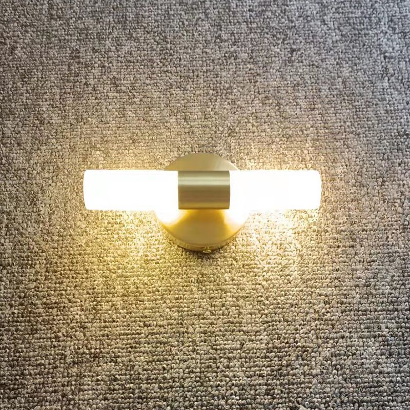 Leigh modern gold LED wall lamp on textured wall