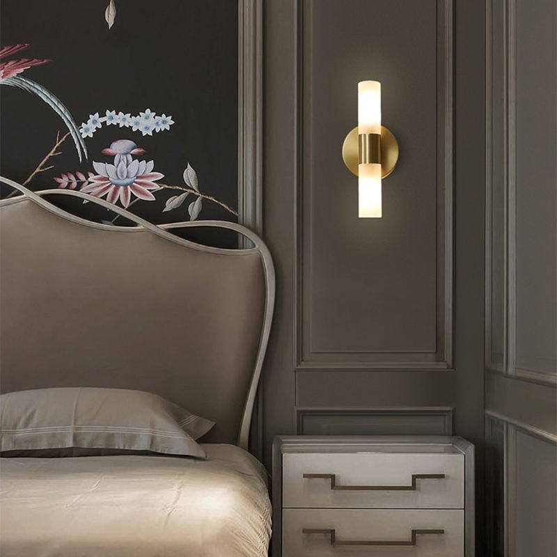 Leigh modern gold LED wall lamp in bedroom setting
