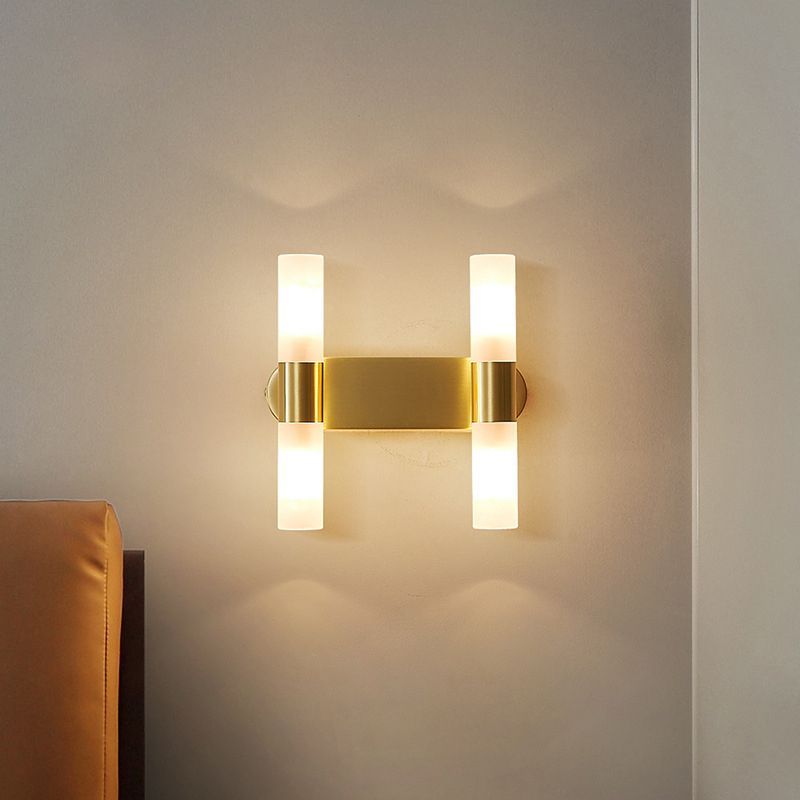 Leigh Modern Gold Wall Lamp illuminating a wall