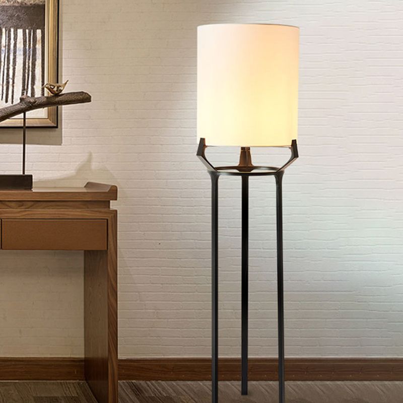 Eryn floor lamp: Metal tripod base with white fabric shade.