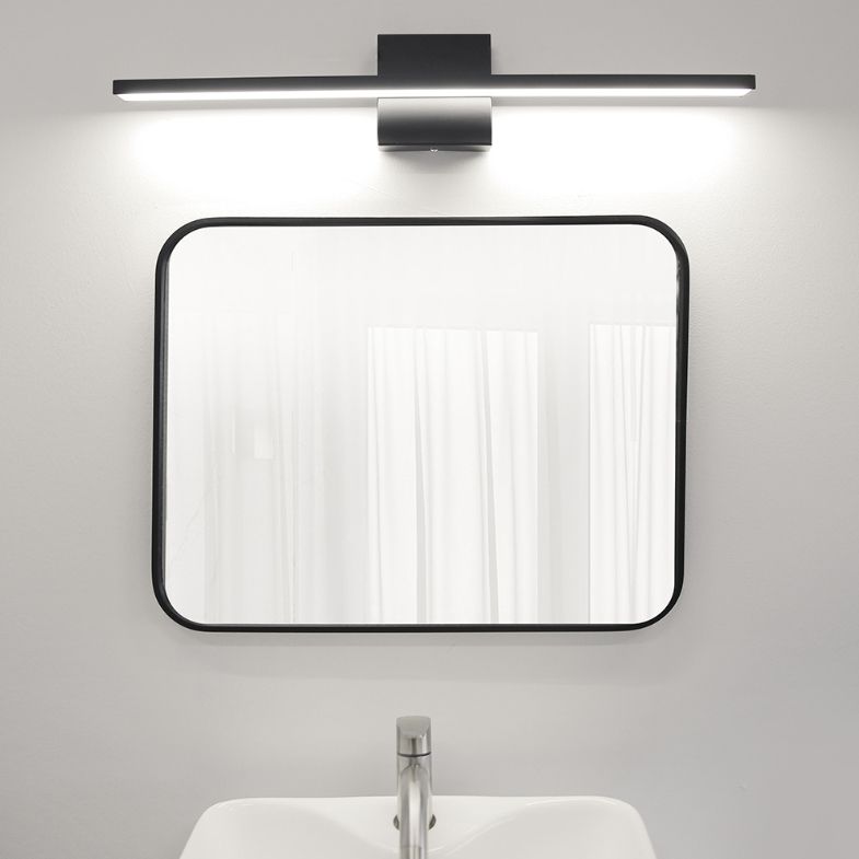 Modern bathroom with black framed mirror and LED wall lamp