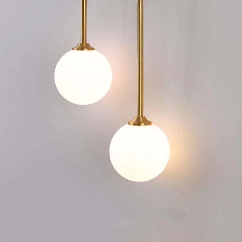 Modern brass wall lamp with globe shades
