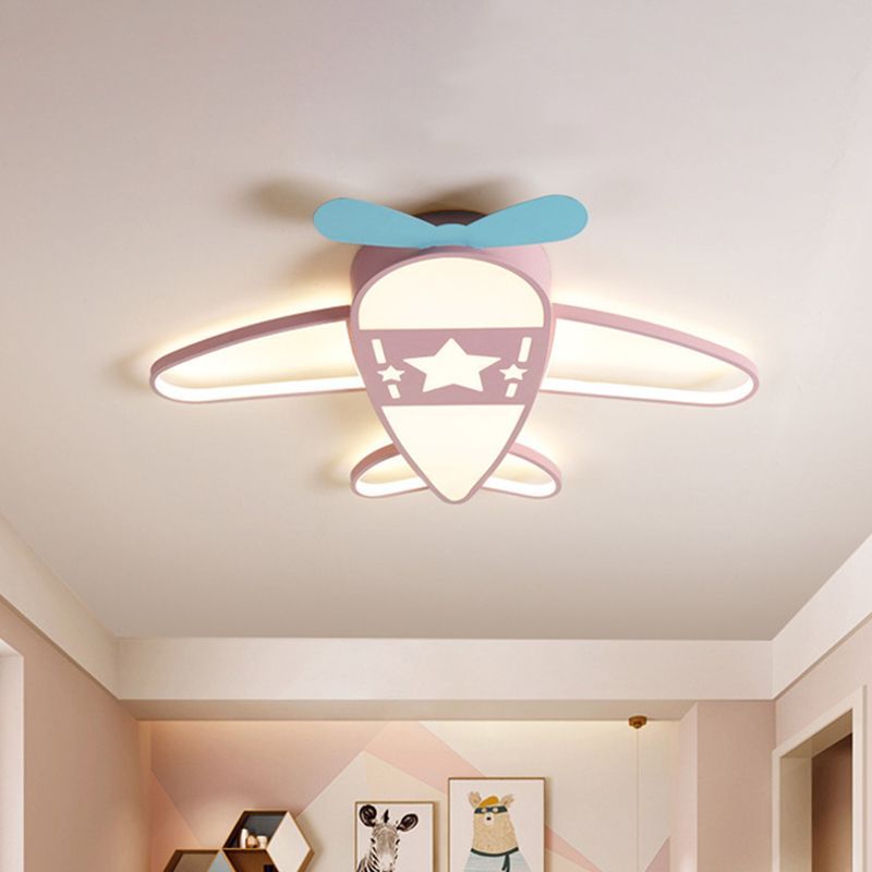 Pink airplane ceiling light fixture in kids bedroom