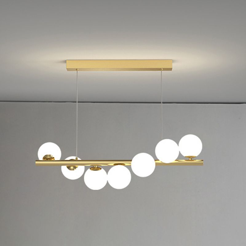 Valentina gold pendant light with white globes