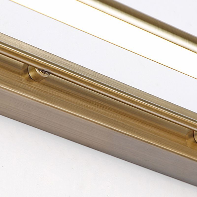 Close-up of gold metal Leigh bathroom vanity light.