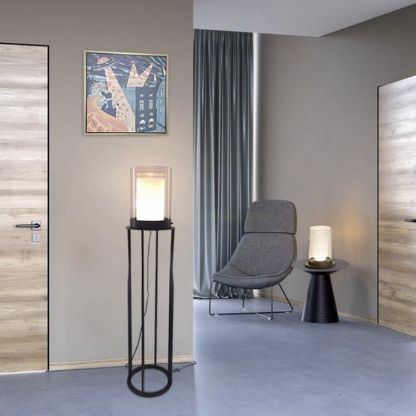 Eryn cylinder floor lamp in living room, metal and glass design.