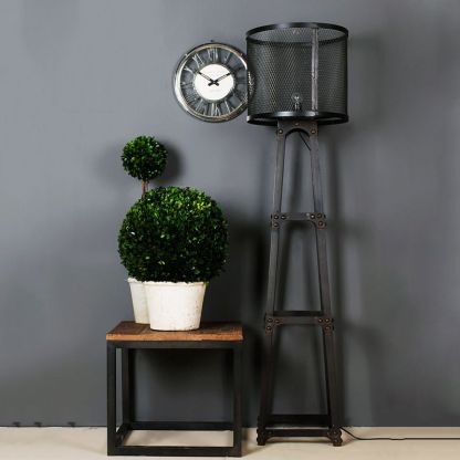 Black metal mesh Alessio floor lamp in living room setting.