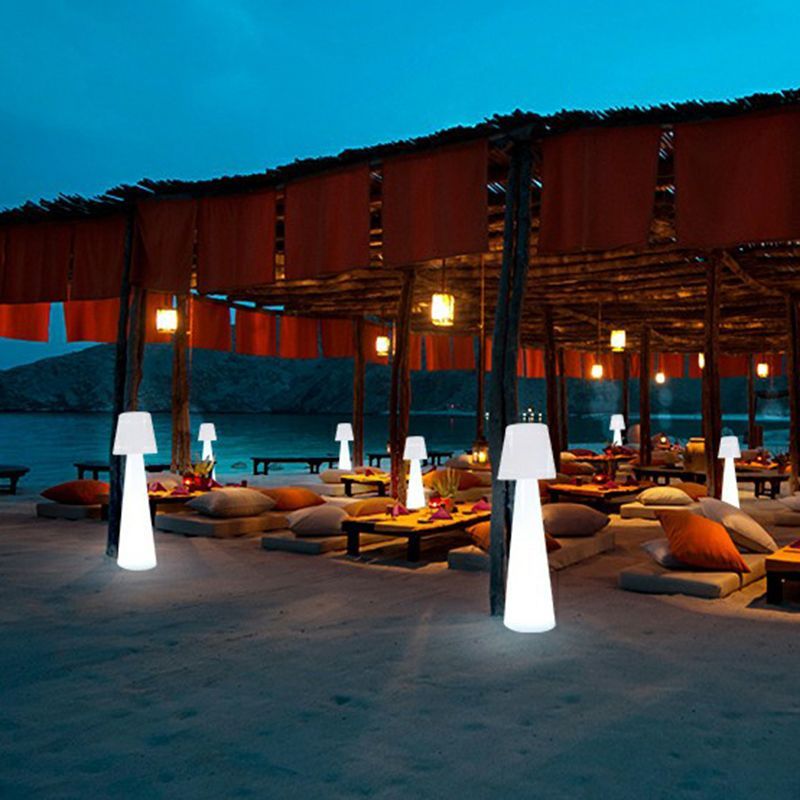 Pena Outdoor Path Lights illuminating a beachside dining setting