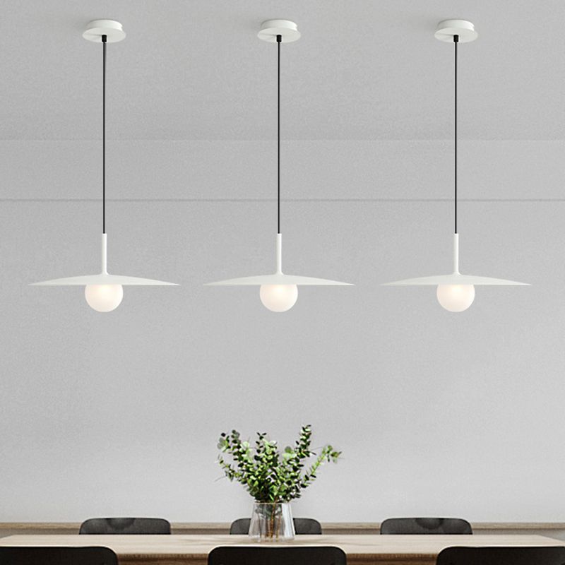 White Carins dish-shaped pendant lights over dining table