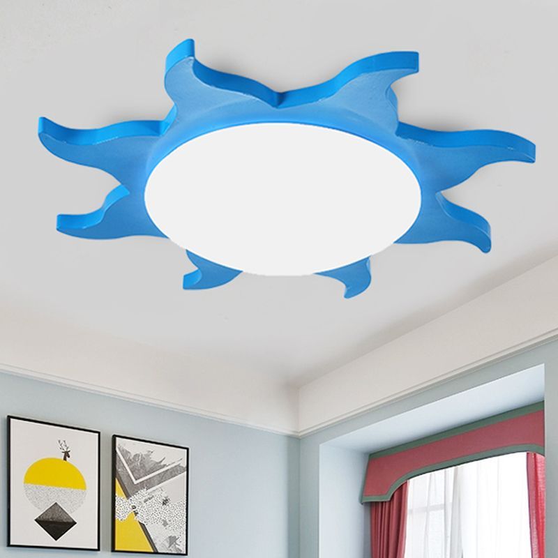 Blue sun-shaped ceiling light in bedroom