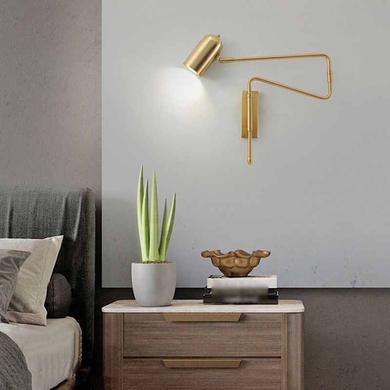 Freja gold metal adjustable wall lamp in bedroom setting