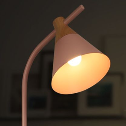 Illuminated pink Morandi floor lamp, metal shade. Modern lighting.