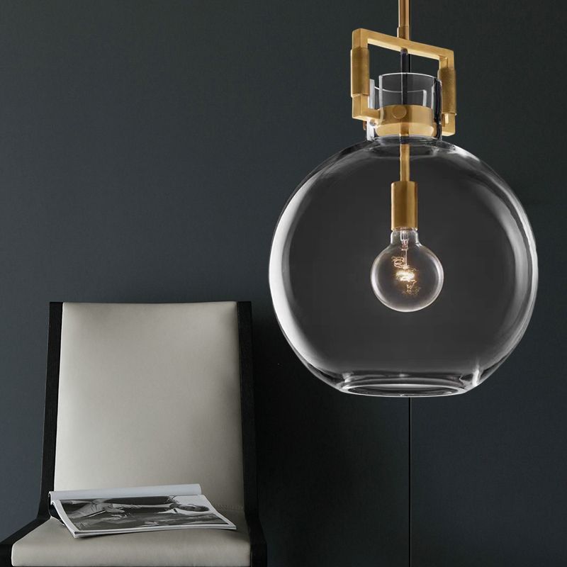 Cairns glass pendant light with brass accents.