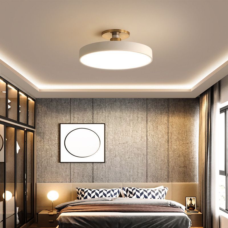 Bedroom with minimalist round flush mount ceiling light