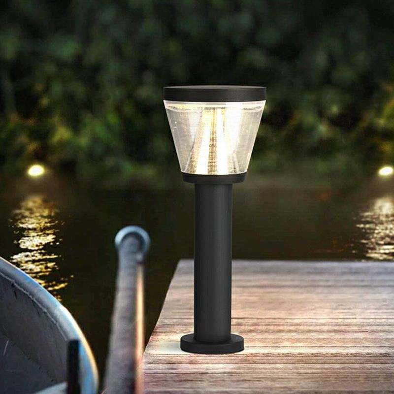 Modern solar bollard light illuminating a dock at night