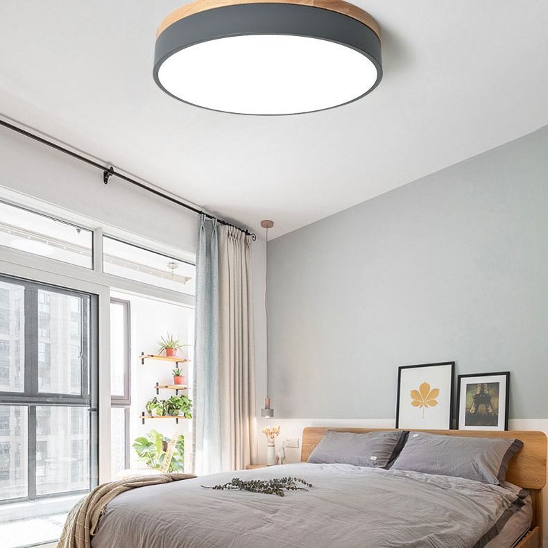 Bedroom with Morandi LED ceiling light. Round flush mount lighting.