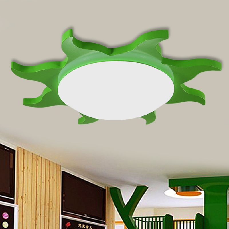 Green sun-shaped ceiling light fixture in bedroom