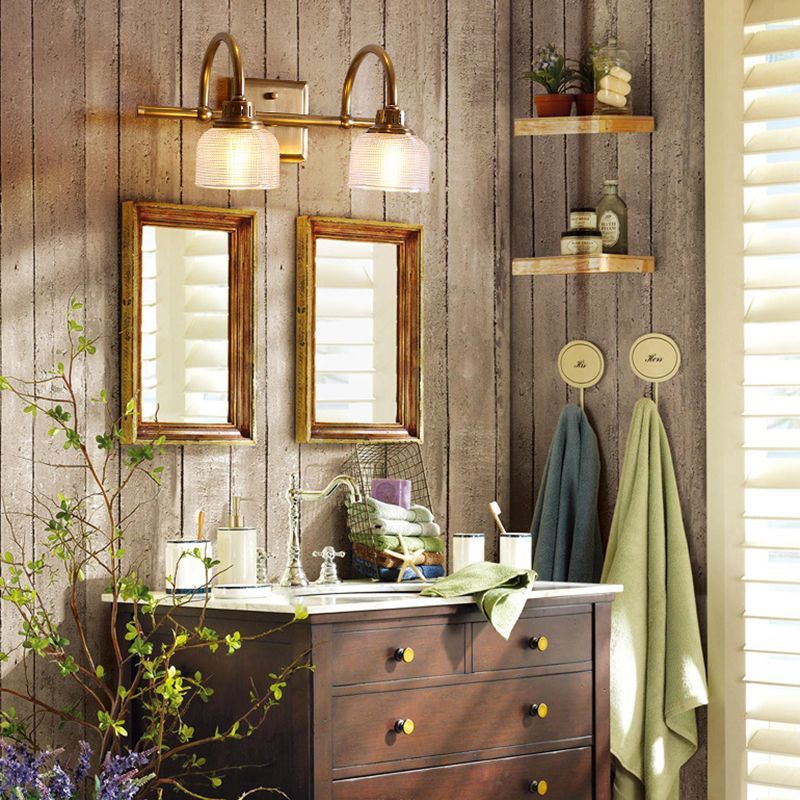 Lottie Prismatic Vanity Wall Lamp in a bathroom setting, brass and glass