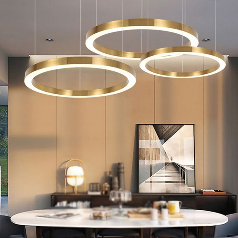 Arisha ring pendant light in dining room. Modern gold lighting fixture.