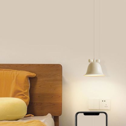 Bell-shaped pendant light with bow in bedroom