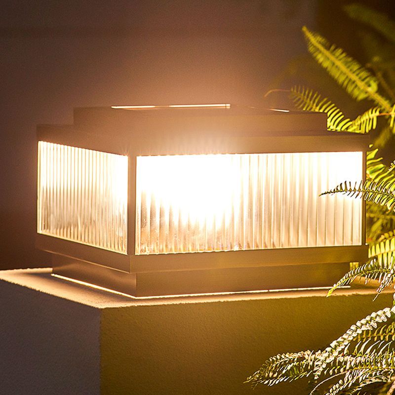 Riley modern outdoor pillar light illuminating at night