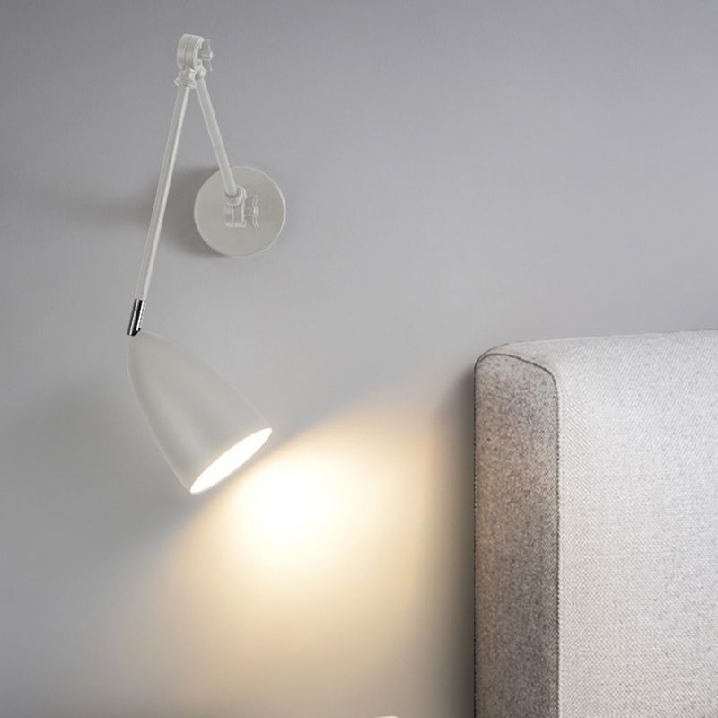 Brady nickel adjustable wall lamp illuminating bedroom