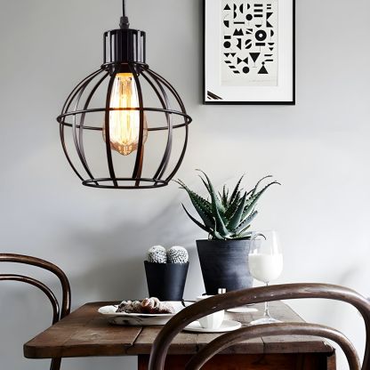 Industrial metal pendant light above dining table.
