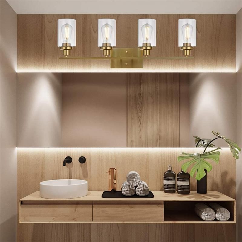 Gold Alessio vanity lamp with clear glass in modern bathroom. Alessio Modern Mirror Front Vanity Wall Lamp Metal Glass