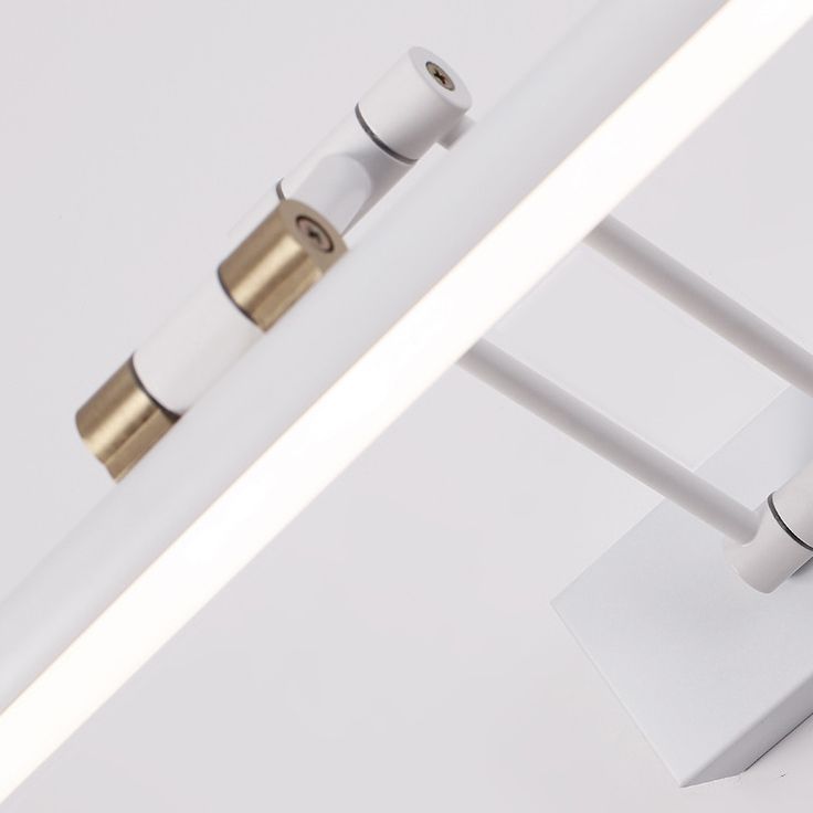 Adjustable LED vanity light, white and brass detail.