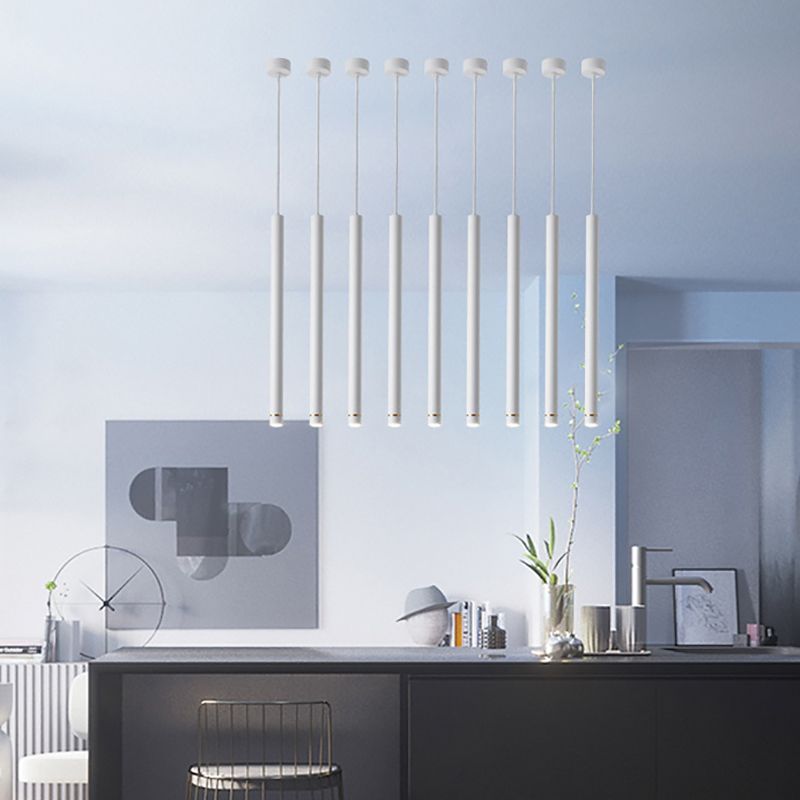 Minimalist cylinder pendant lights over kitchen island
