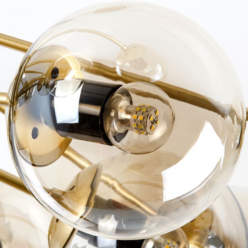 Close-up of Valentina gold pendant light with glass sphere shades