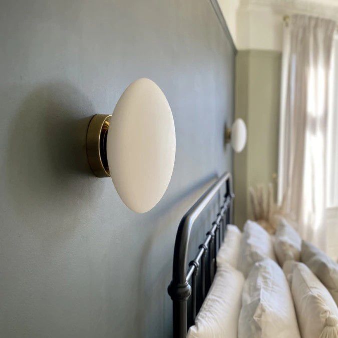Valentina wall lamp illuminating a bedroom wall, modern lighting
