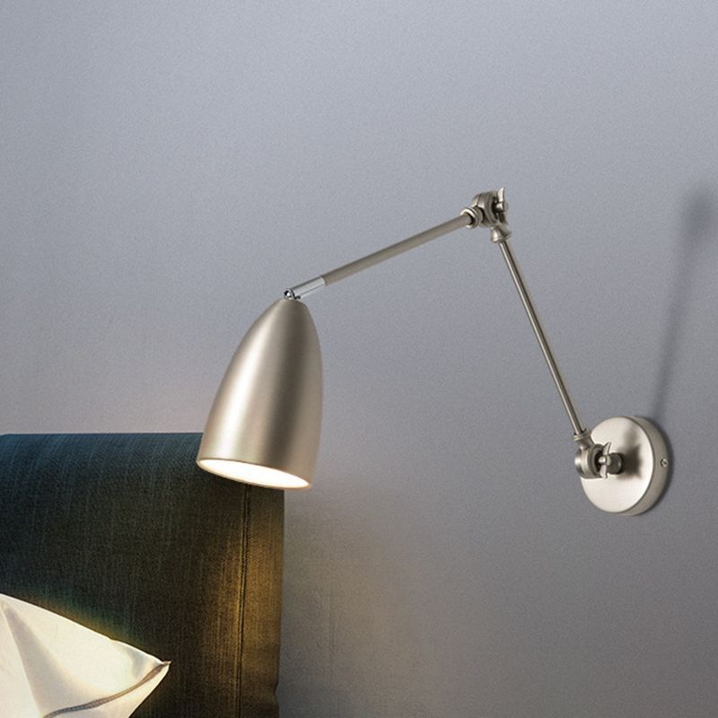 Brady nickel adjustable wall lamp shining in bedroom