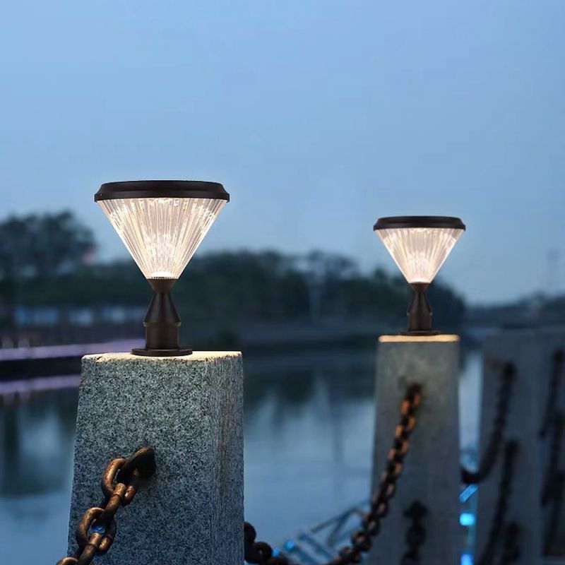 Riley Outdoor Pillar Lights illuminating a walkway at dusk