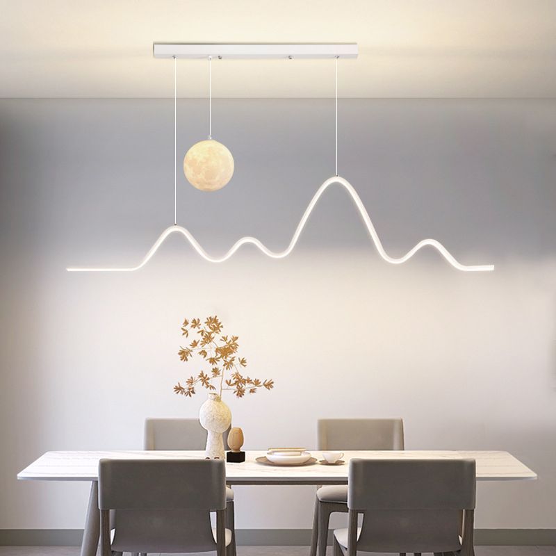 Minimalist wavy metal pendant light over dining table